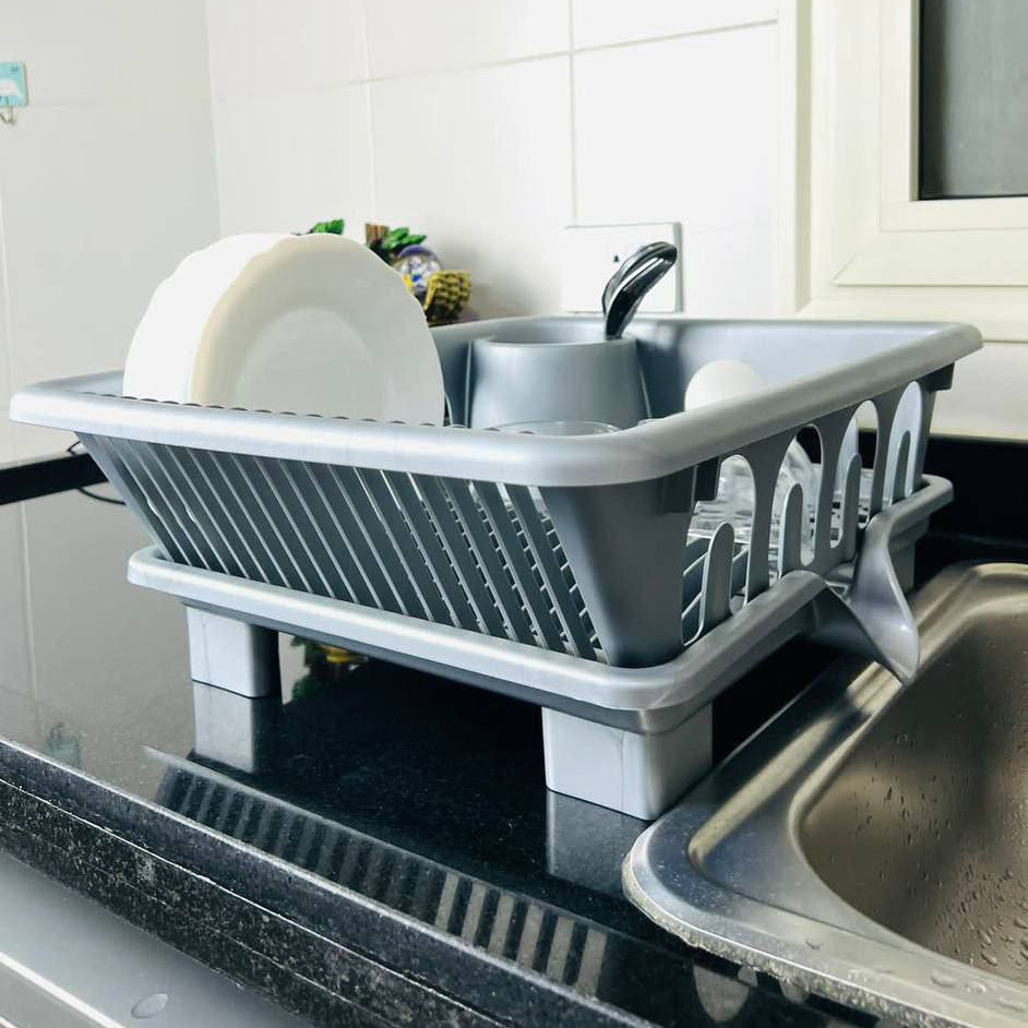 Gray dish rack on a kitchen counter with dishes inside