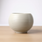 White ribbed ceramic vase on a white background