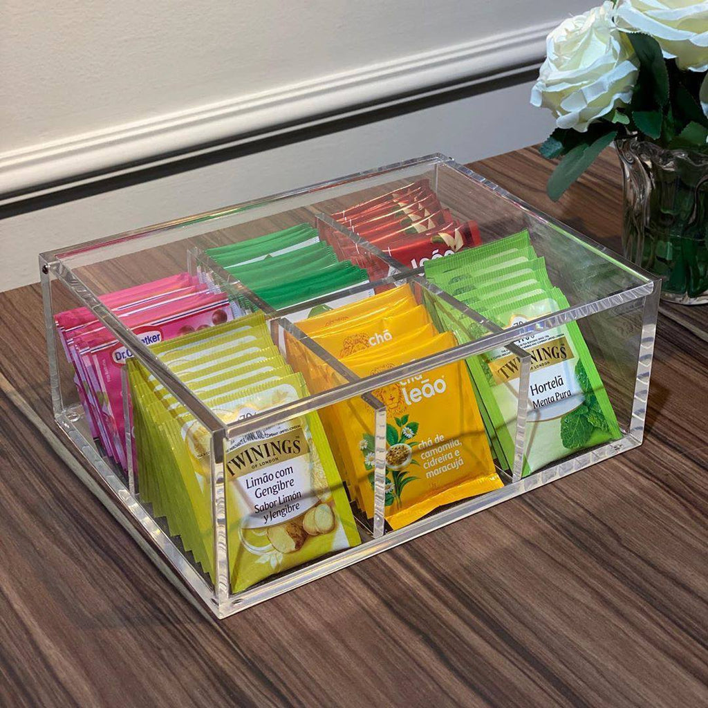 Clear acrylic organizer with tea bags on a wooden surface