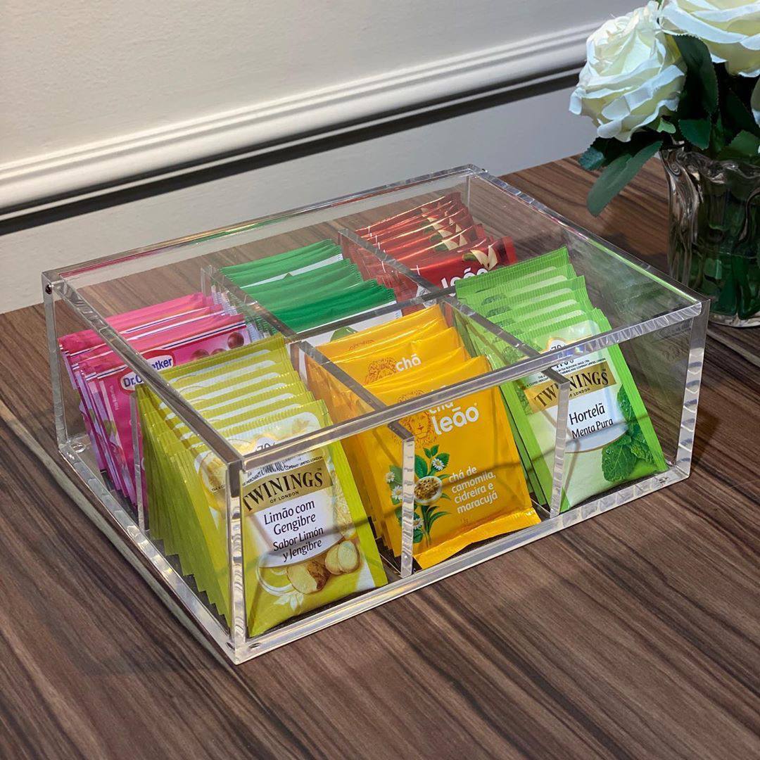Clear acrylic organizer with tea bags on a wooden surface